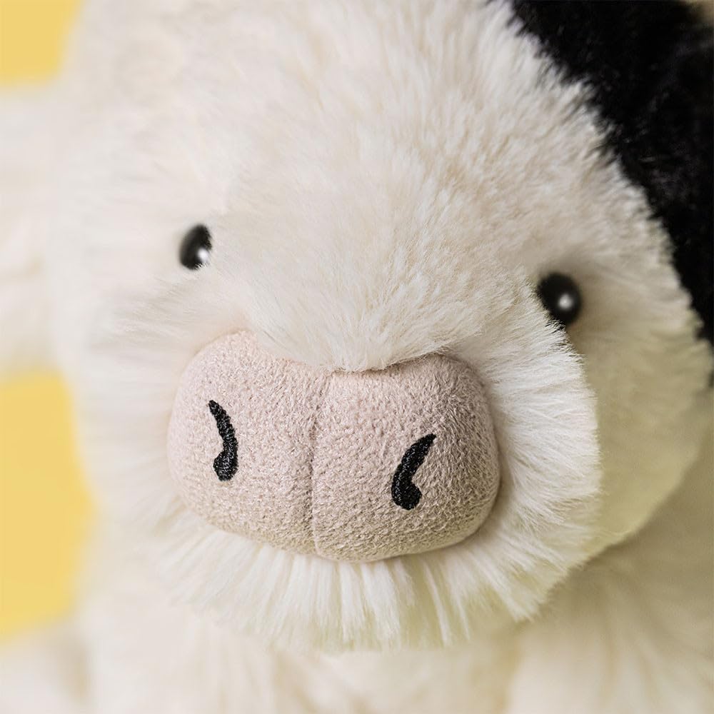 Jellycat Smudge Cow closeup highlights soft polyester cuddle appeal.