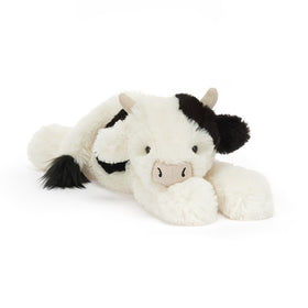 Jellycat Smudge Cow in golf stance for playful decor and whimsy.