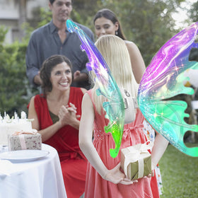 Johehe glowing wings worn by a girl for a fairy costume at a party