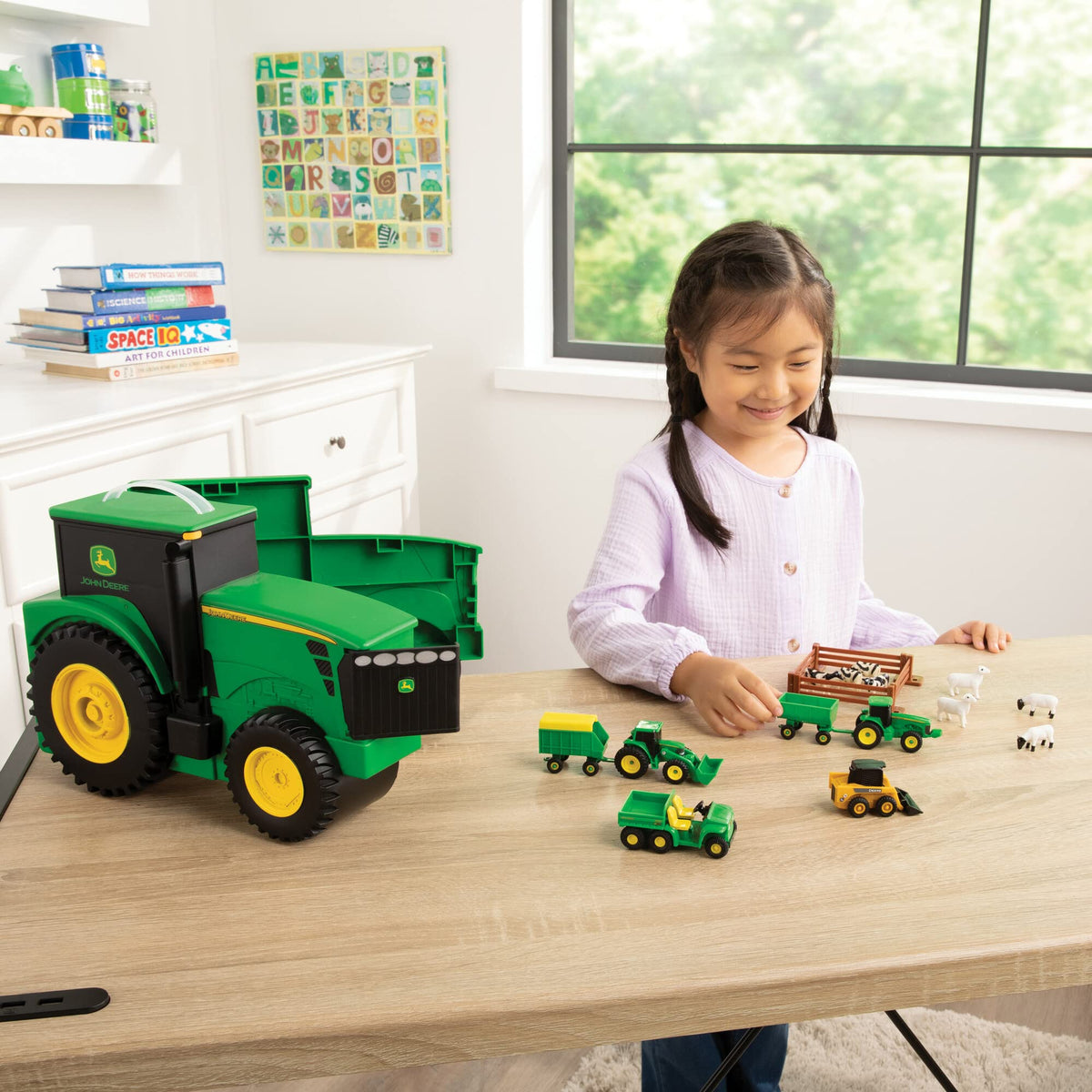 Collectible John Deere farm animals, wagons, and fencing in a box.