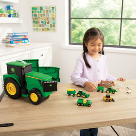 Collectible John Deere farm animals, wagons, and fencing in a box.