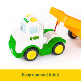 Ramp raises and lowers to guide tractor onto the trailer
