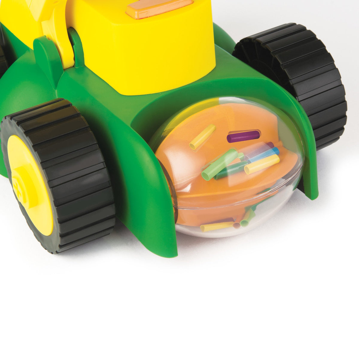 John Deere Tomy lawn mower shows rotating grass clippings for realism.
