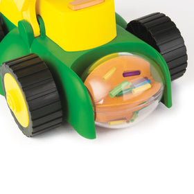 John Deere Tomy lawn mower shows rotating grass clippings for realism.