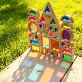 Close-up of rainbow acrylic windows on JOLKID blocks showing vibrant color on a surface.