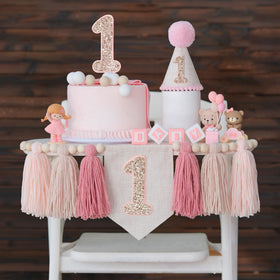 JUIIZAY pink first birthday banner over a high chair for sweet photos.