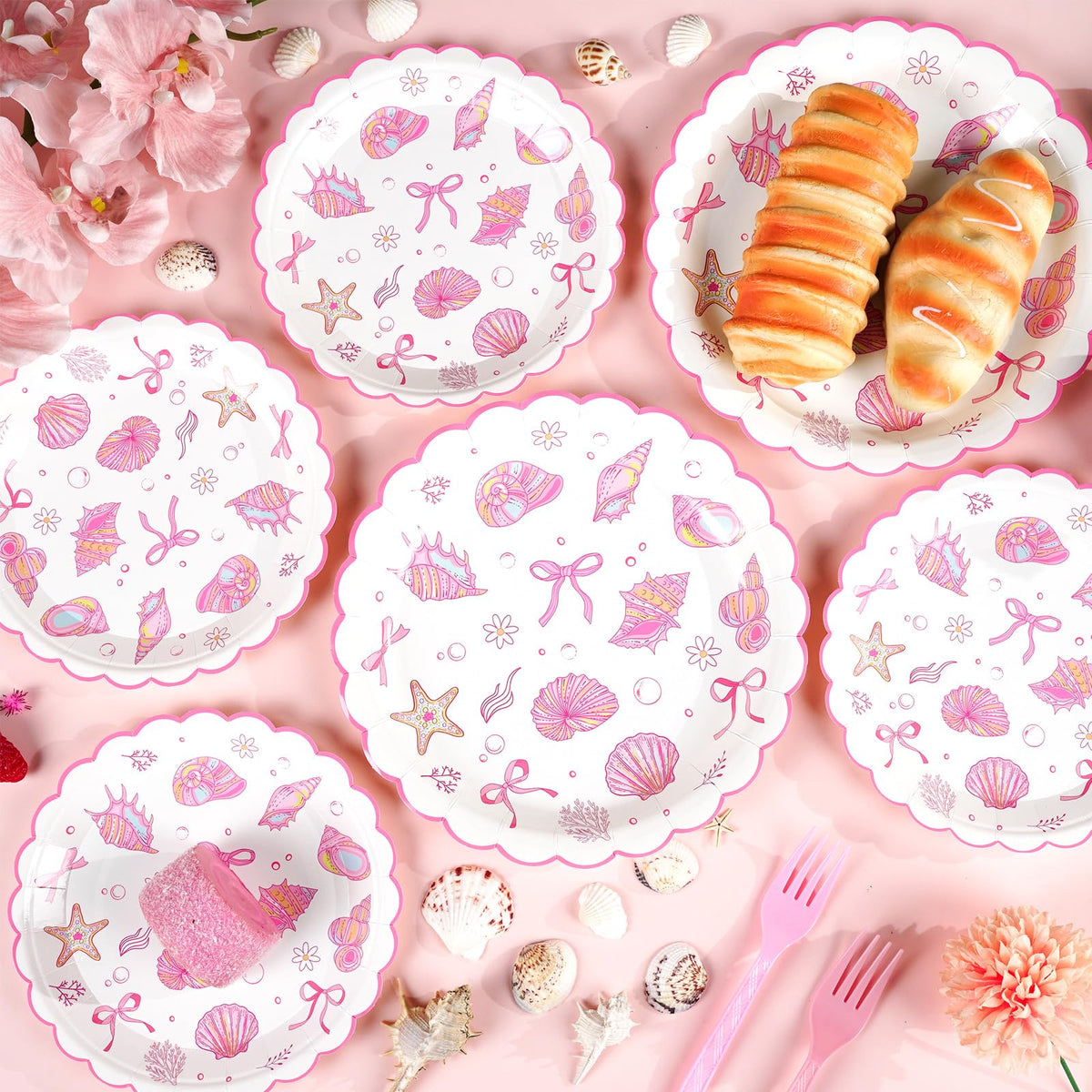 Justforjoyful scalloped edges plates with pink bows add refined coastal flair.