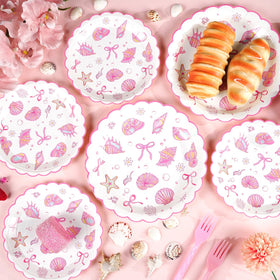 Justforjoyful scalloped edges plates with pink bows add refined coastal flair.
