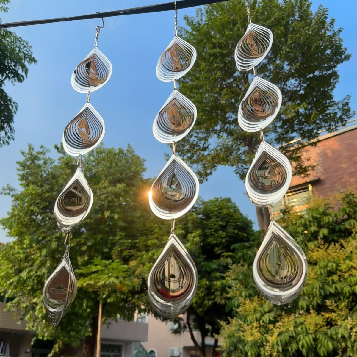 Kexsscai Water Droplets Disc side view reflecting sunlight to deter garden birds.