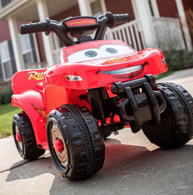 Kid Trax Lightning McQueen quad side view showing flame decals for action-ready fun.