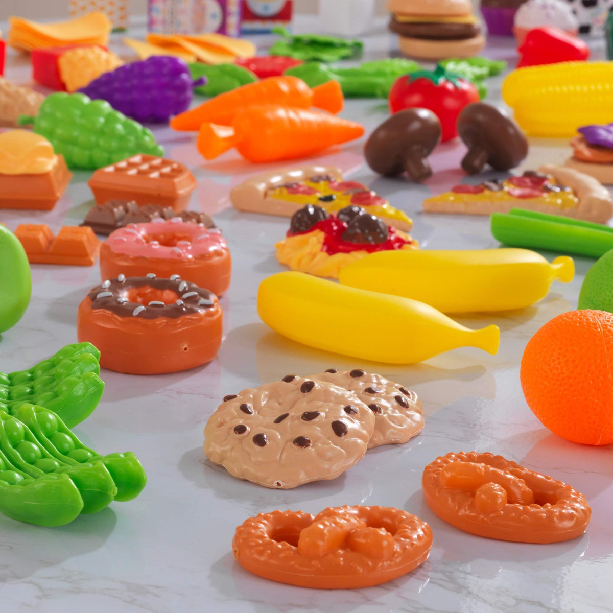 KidKraft Tasty Treats cooking ingredients enable realistic kitchen scenes.