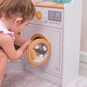 KidKraft Ultimate Corner Play Kitchen washing machine with sudsy graphics for laundry play