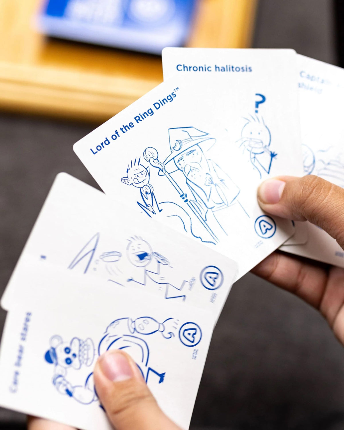 Kids Against Maturity blue question cards showcased for humorous prompts and fast play