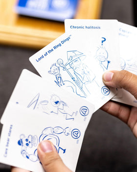 Kids Against Maturity blue question cards showcased for humorous prompts and fast play