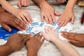Laughter around the table with Kids Against Maturity during a game session