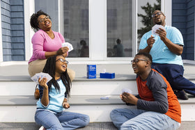 Kids Against Maturity play promo scene highlighting family laughter and togetherness