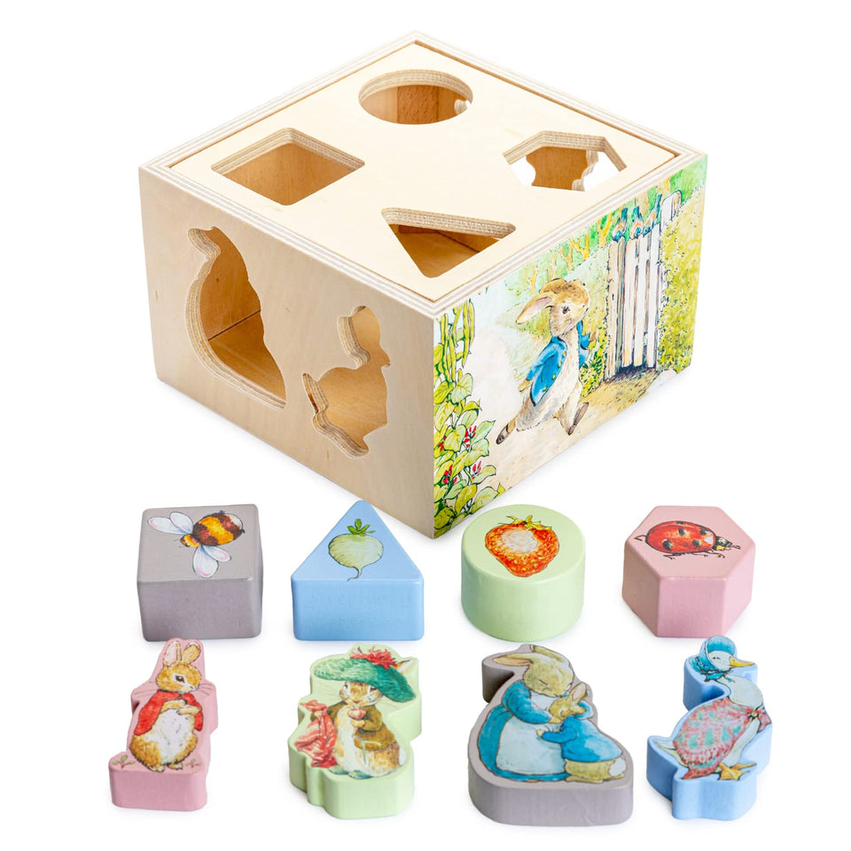 KIDS PREFERRED Peter Rabbit wooden shape sorter with colorful blocks for early shape recognition.