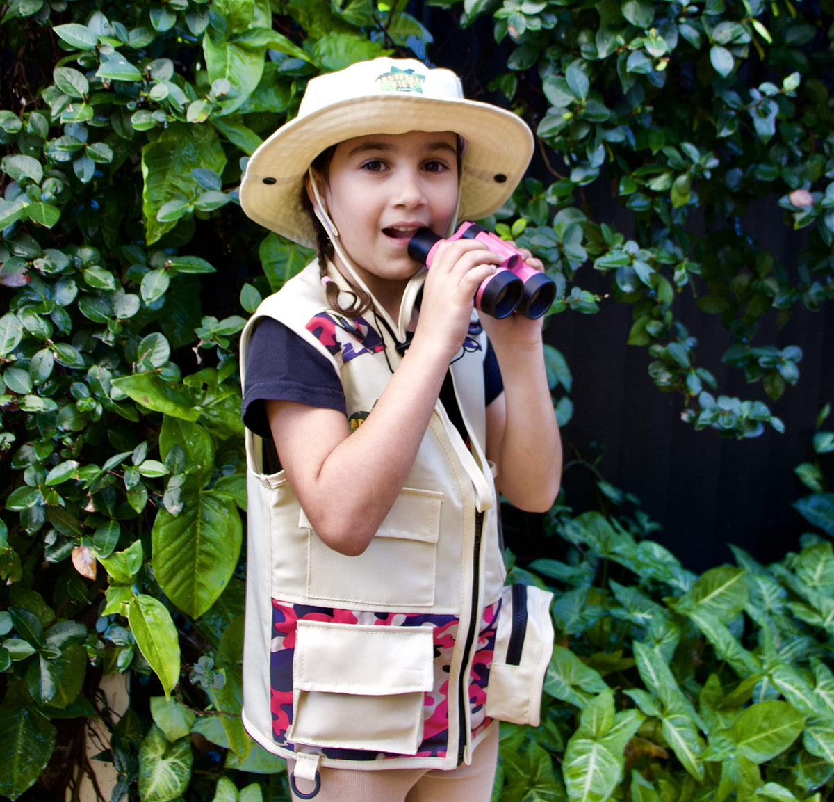 Kidz@Play child wearing vest and hat during outdoor exploration.