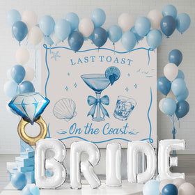 Kozee Last Toast on the Coast balloon garland creates a vibrant coastal backdrop for photos.