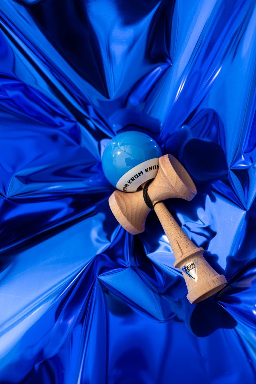 KROM Kendama POP LOL features flexible string for smooth play.