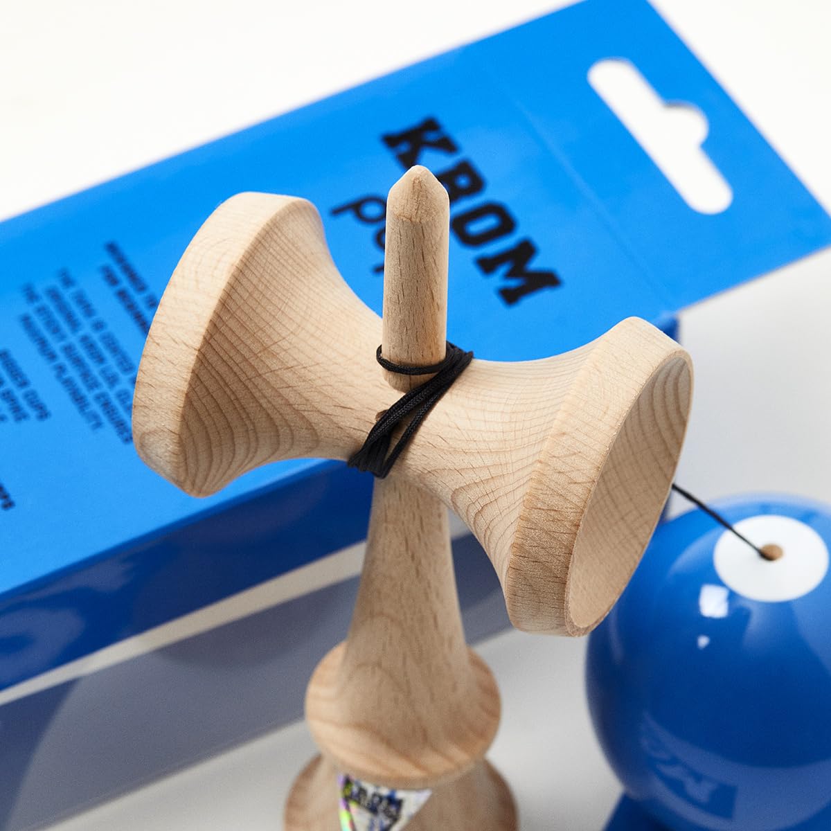 KROM Kendama gift pack includes extra string and stickers for customization.