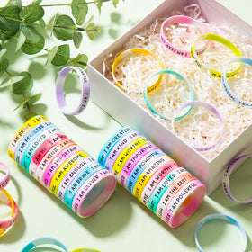 Close-up of KUCLIN wristbands showing motivational quotes for confidence