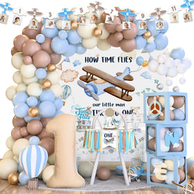 Kudapity Time Flies balloon arch backdrop for a sky-themed first birthday photo moments