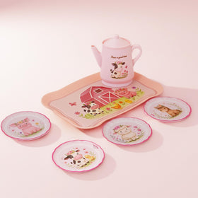 Lajeje Child serving tea during cozy pretend tea party.