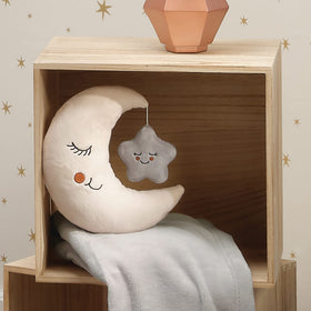 Nursery scene featuring Goodnight Moon plush complements crib and shelf decor.