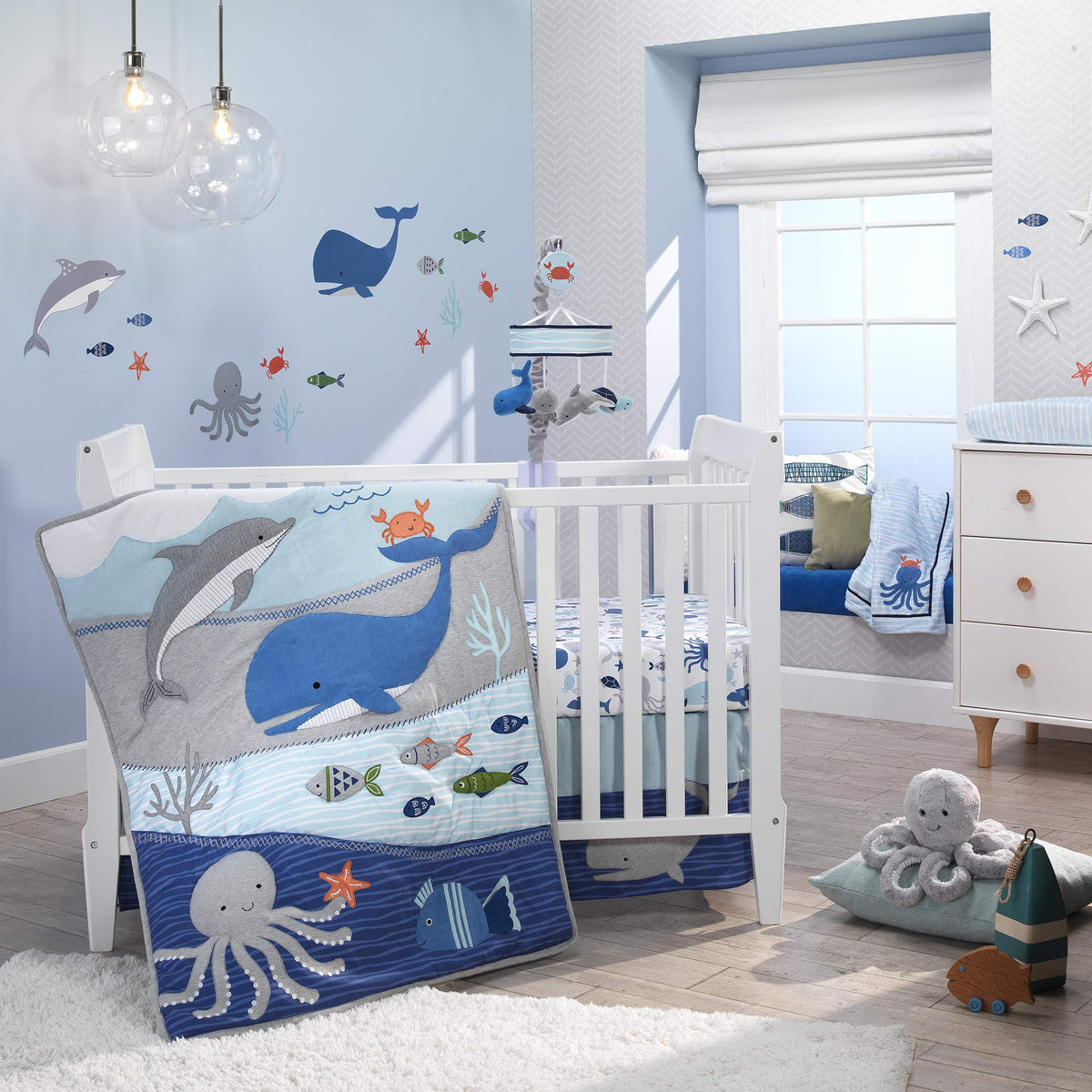Inky octopus plush with decorative pompoms, ideal for nursery decor