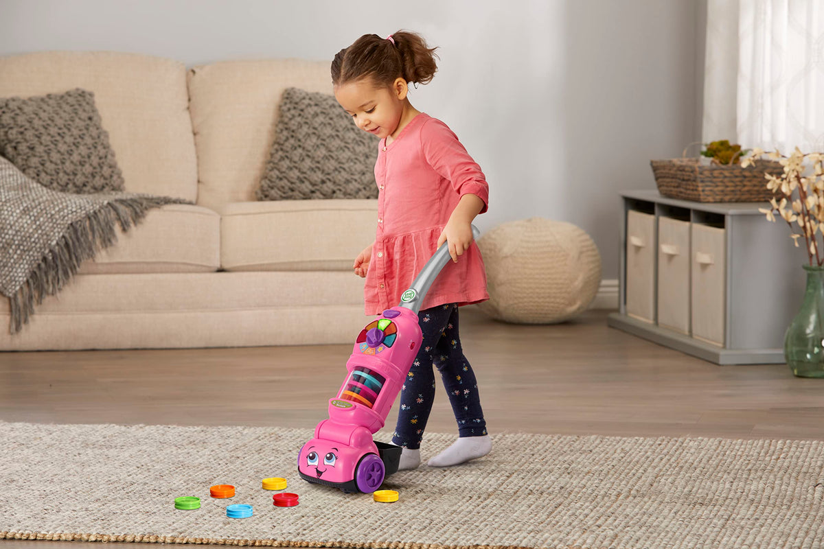 LeapFrog pink dust bin stores all ten dust pieces after pretend cleanup.