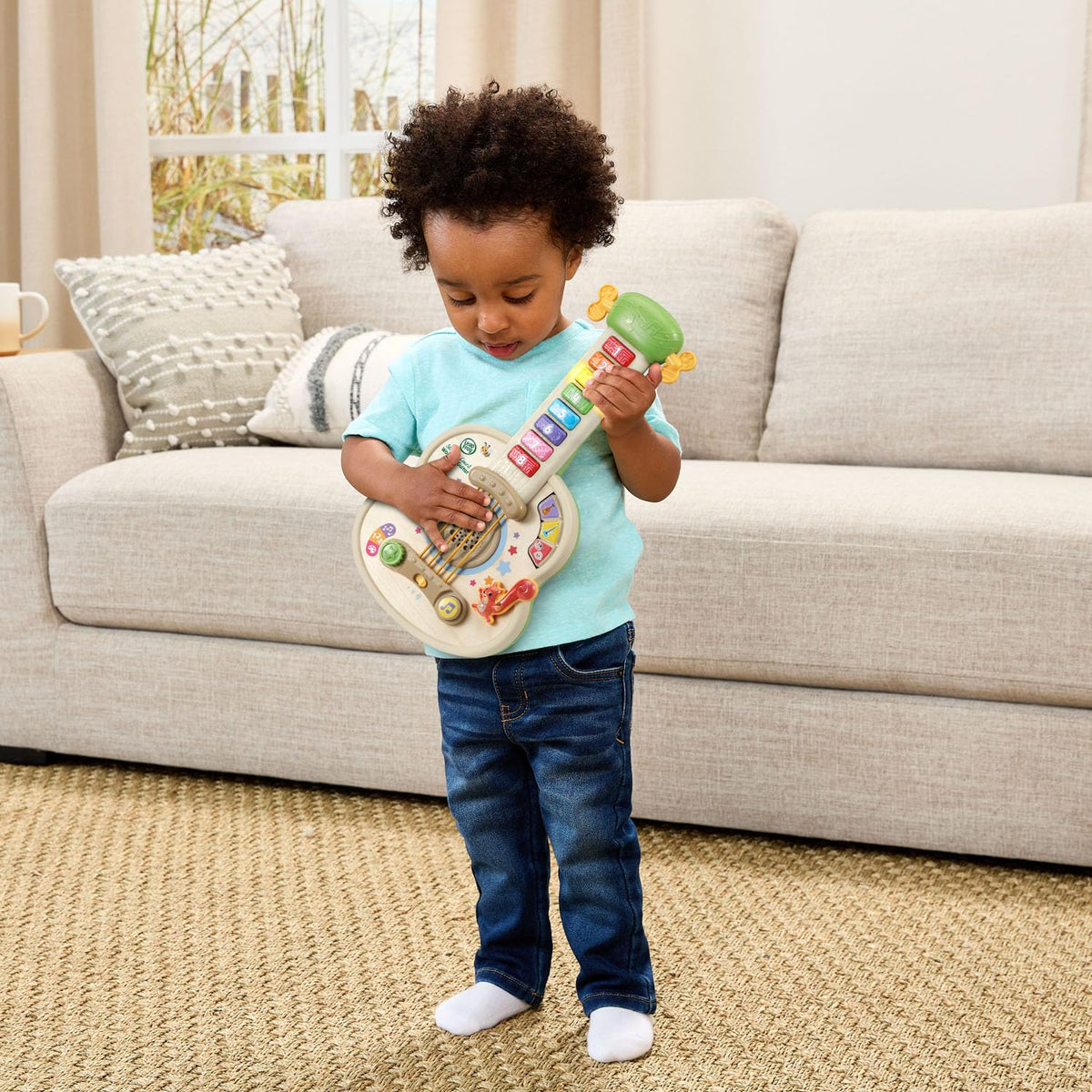 LeapFrog Strum and Count wooden guitar squirrel tail triggers music and language games.