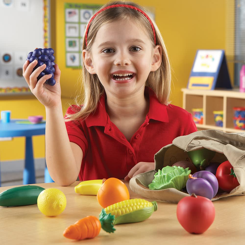 Close-up of red apple and carrot on Learning Resources tote for safe play