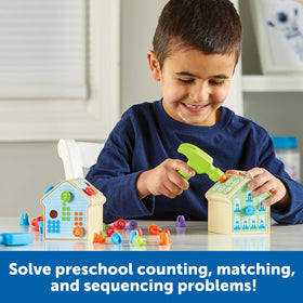 Learning Resources Number Nails child hammering to build fine motor skills.