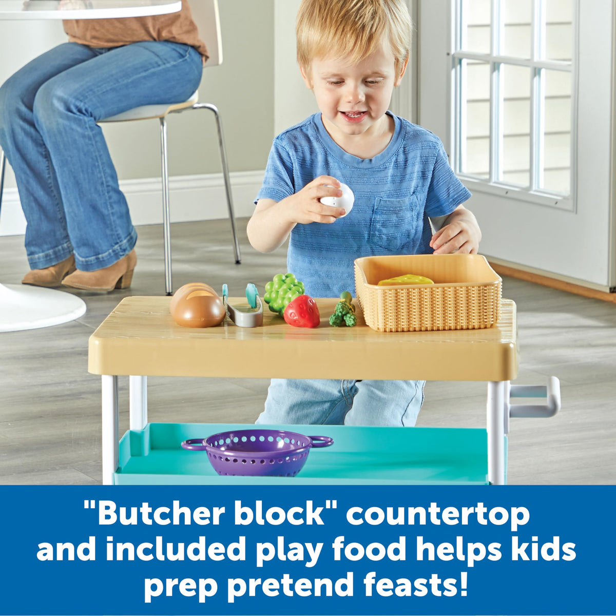 Learning Resources Prep n Store Kitchen Island shelves with baskets keep accessories neat.