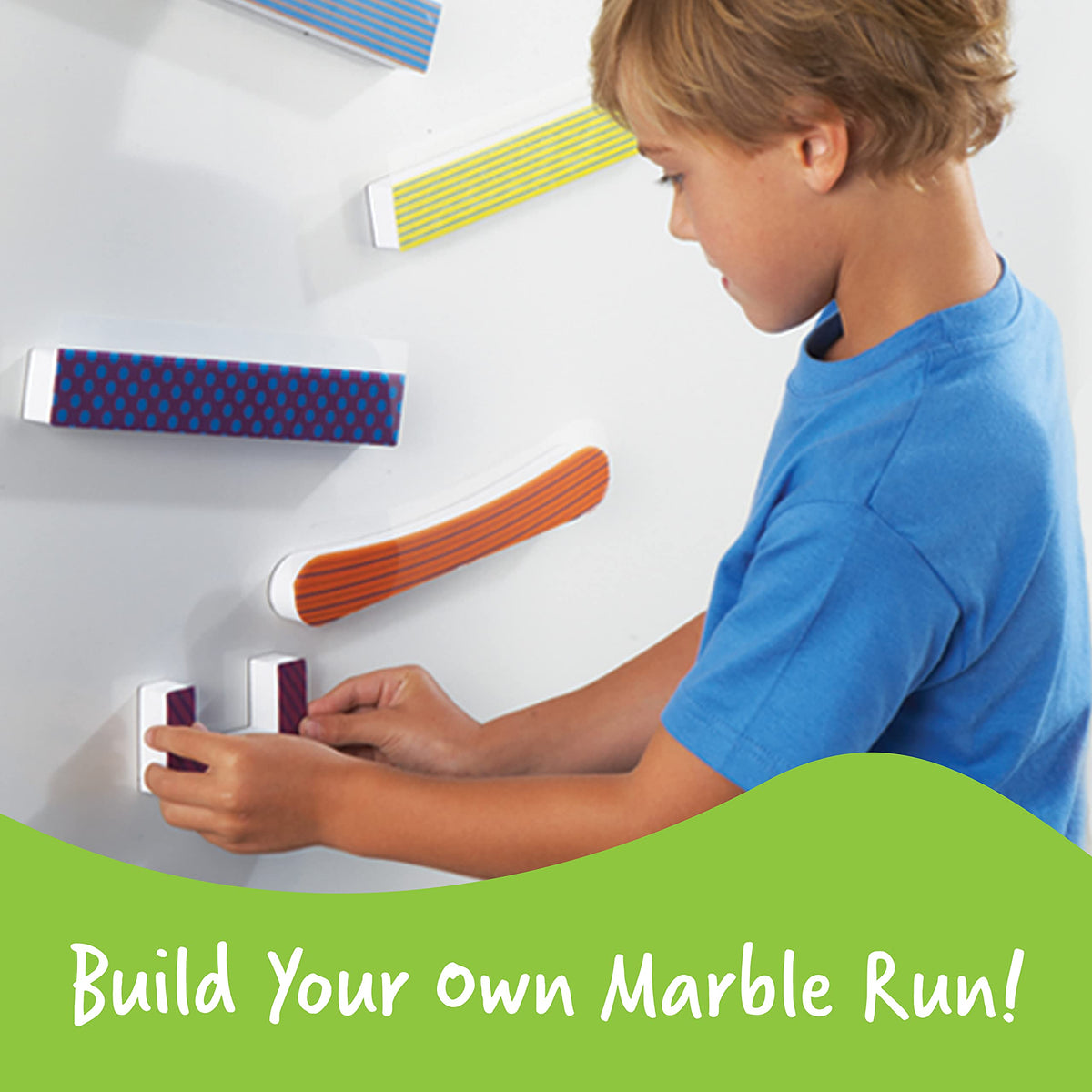 Learning Resources Tumble Trax marbles rolling along a curved path demonstrates gravity.