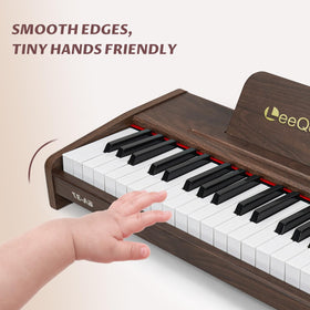 LeeQee 37-Key wooden piano in hand demonstrates portable learning on the go