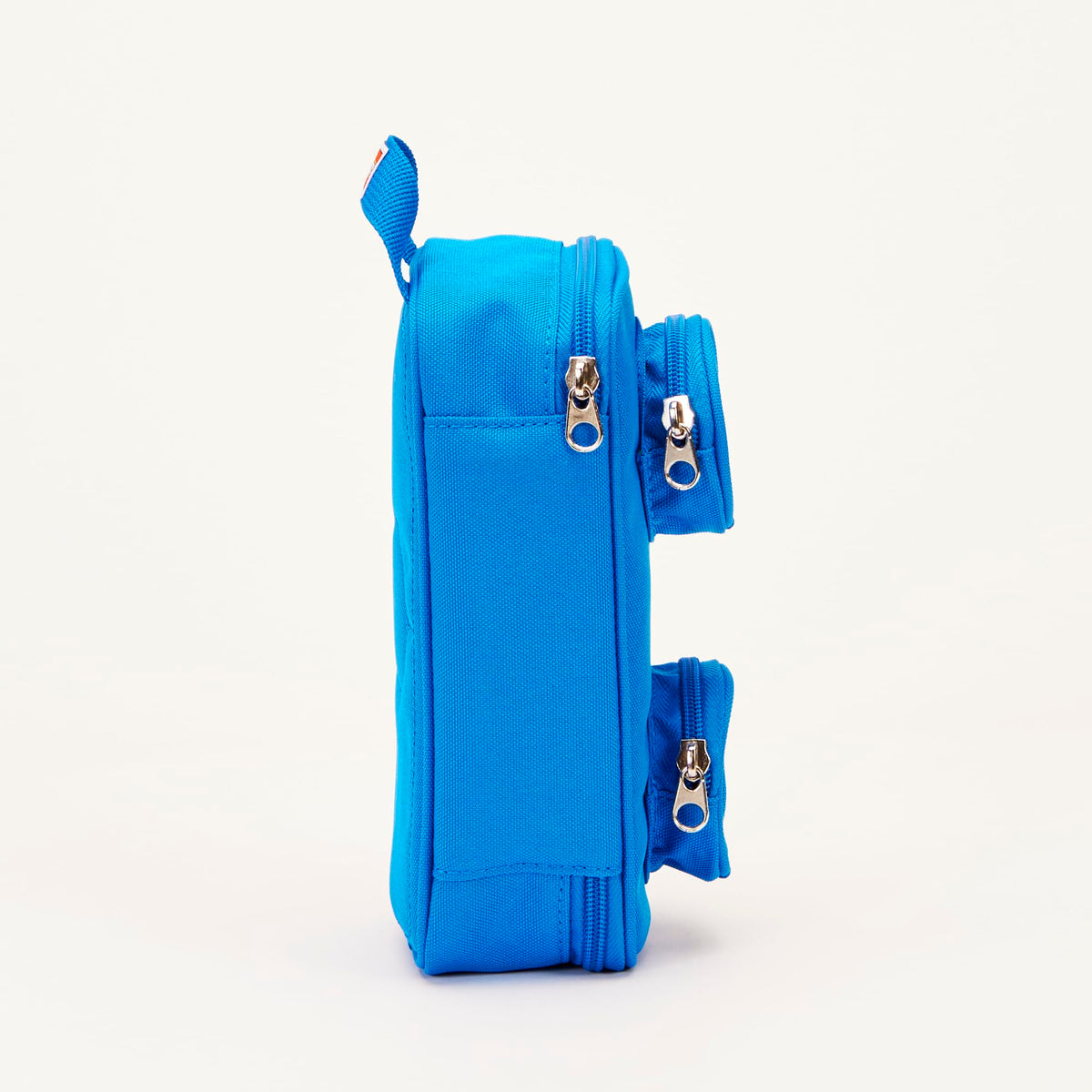 LEGO Brick Pouch blue open compartment reveals roomy main pocket for notebooks and chargers.