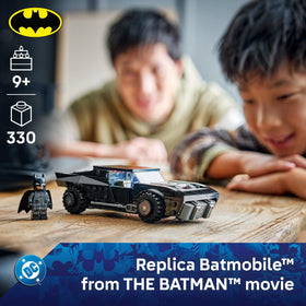 LEGO Batman minifigure with fabric cape inside Batmobile cockpit.