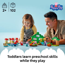 LEGO DUPLO wheelbarrow in Peppa Pig garden—encourages fine motor play