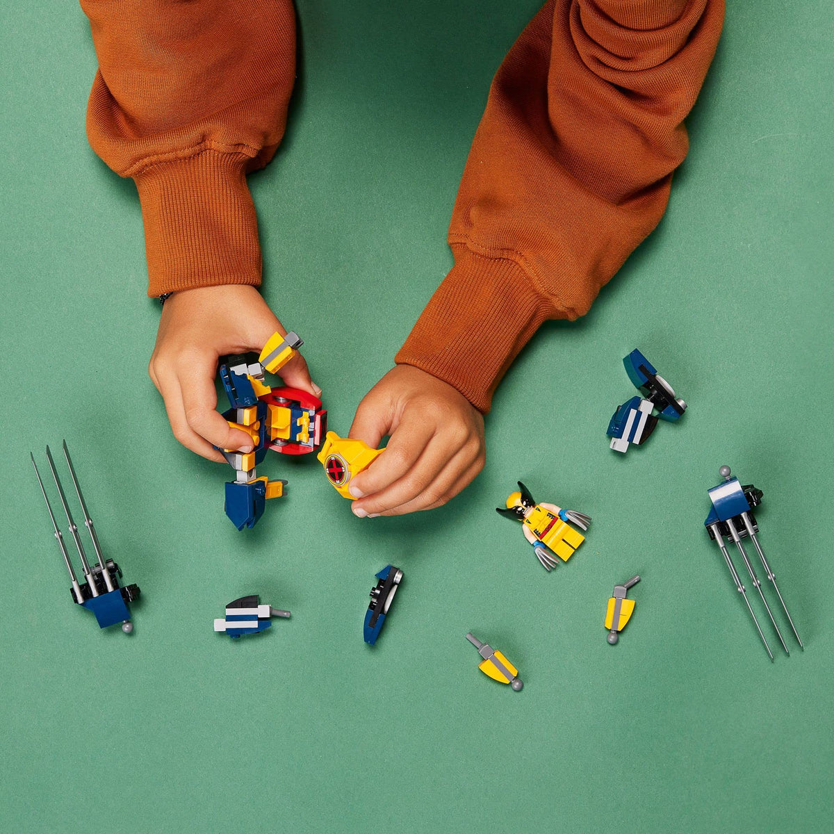 LEGO Marvel Wolverine Mech Armor battle scene with articulated limbs.
