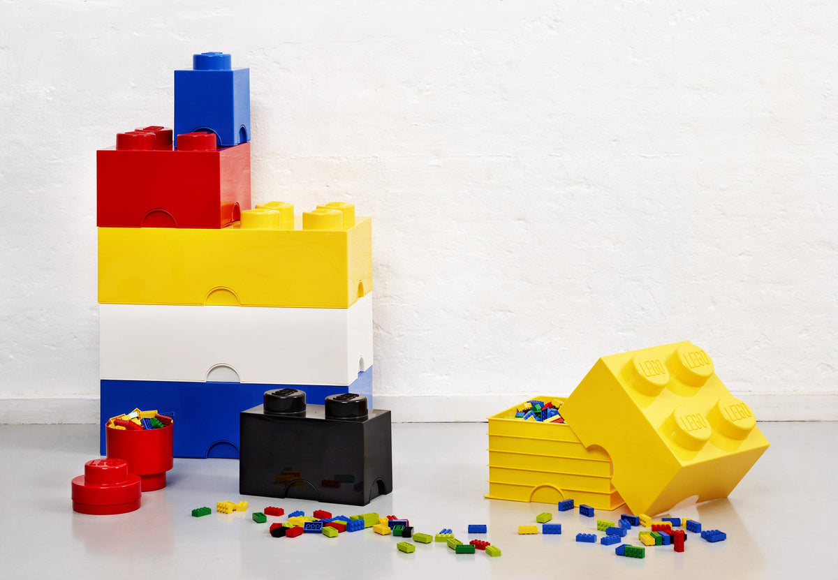 LEGO Room Copenhagen yellow brick drawer filled with colorful bricks.