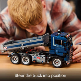 LEGO Technic tipping dump truck building action conveys engaging construction-worthy assembly process.