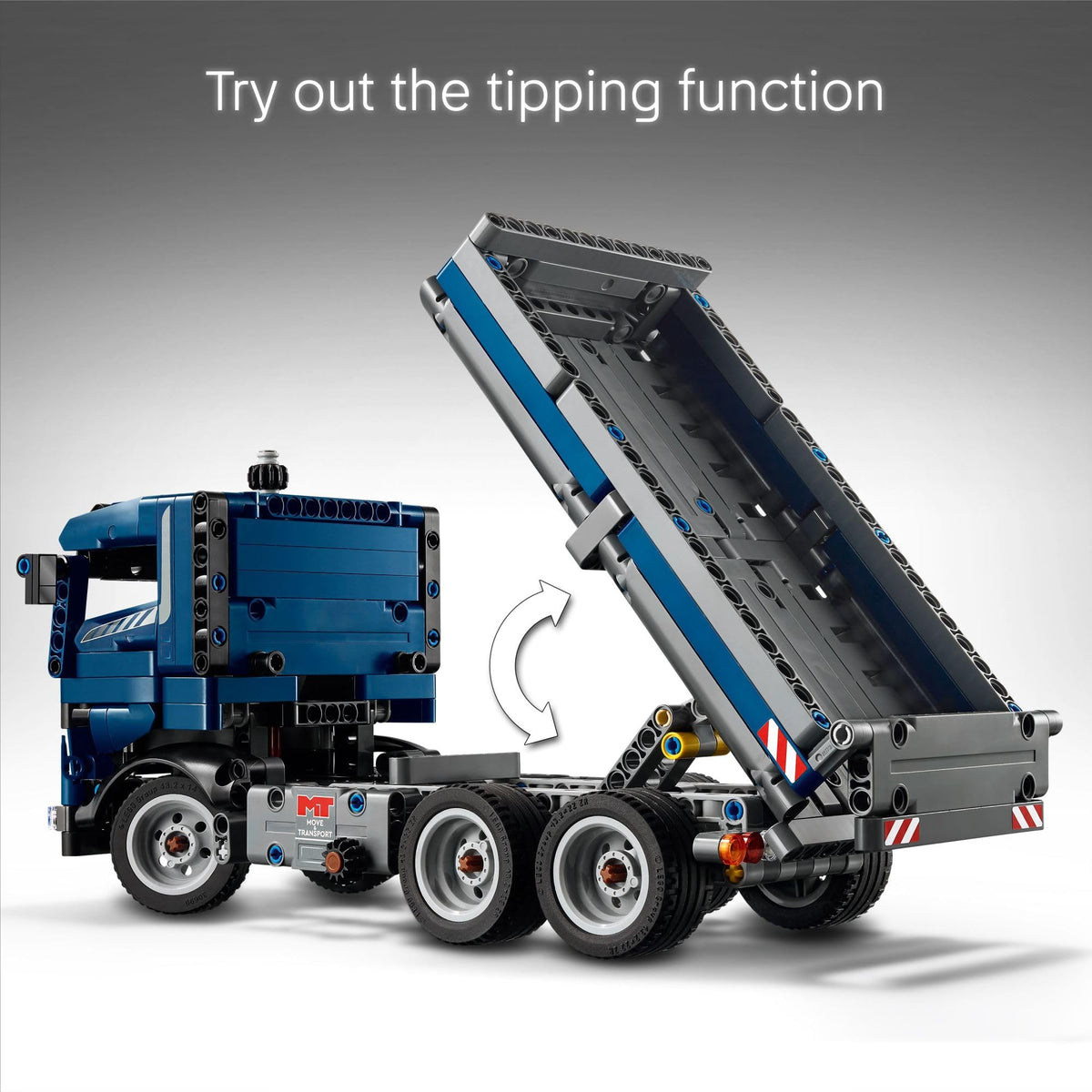 LEGO Technic tipping dump truck open doors highlights accessible cab and scene setup.