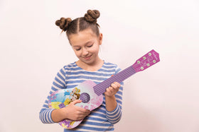 LEXiBOOK Disney Princess guitar in use by a child shows lightweight design.