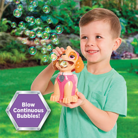 Child blowing bubbles with Skye bubble blower during park or beach time