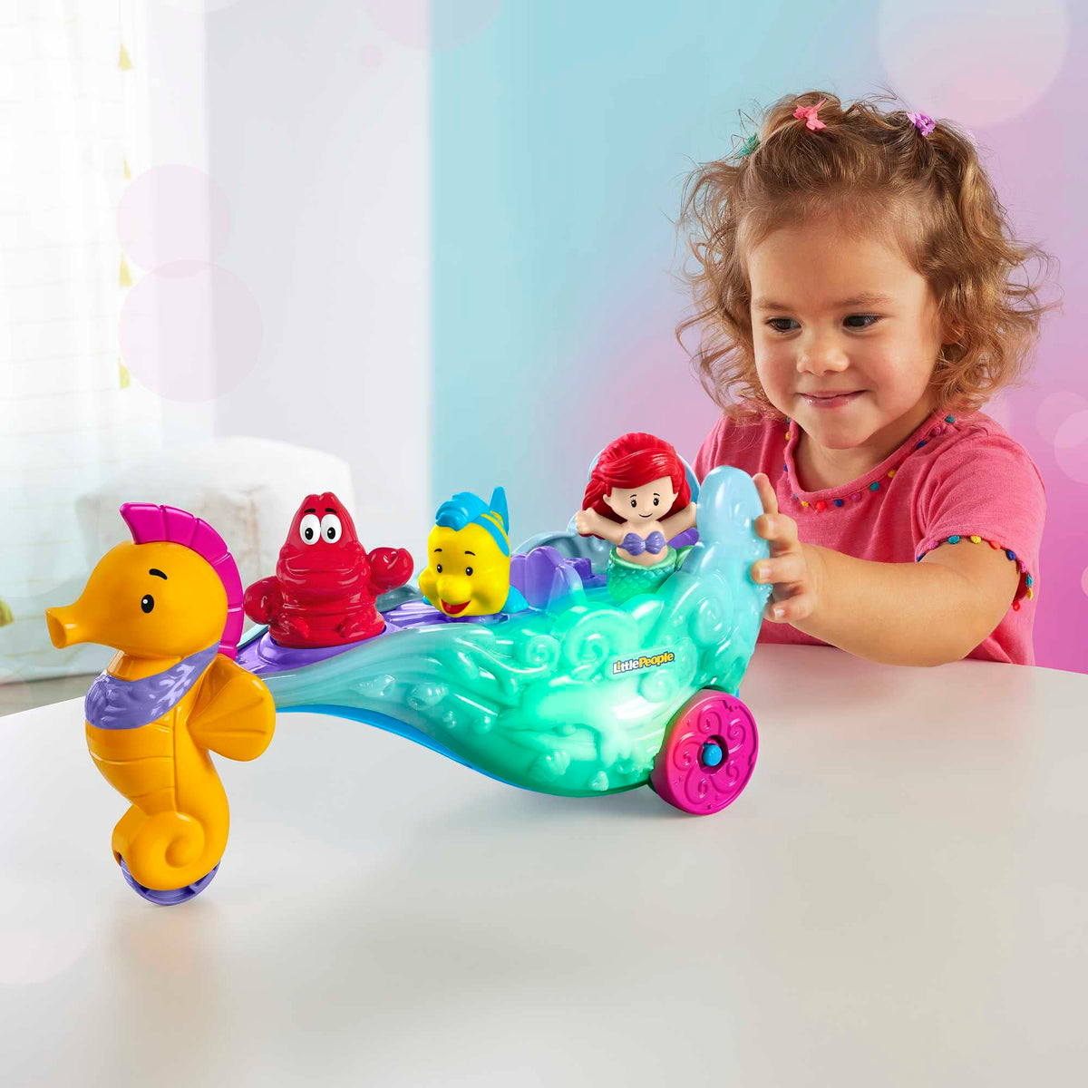Little People push-along sea carriage supports motor skills during pretend adventures.
