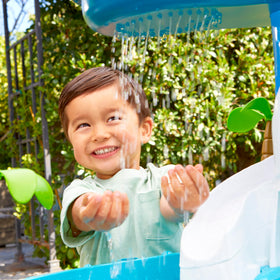 Little Tikes Waterfall Island Water Table kid-powered wheel creates ocean-like waves.