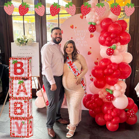 Lopeastar strawberry banner brightens the space for a joyful baby shower theme