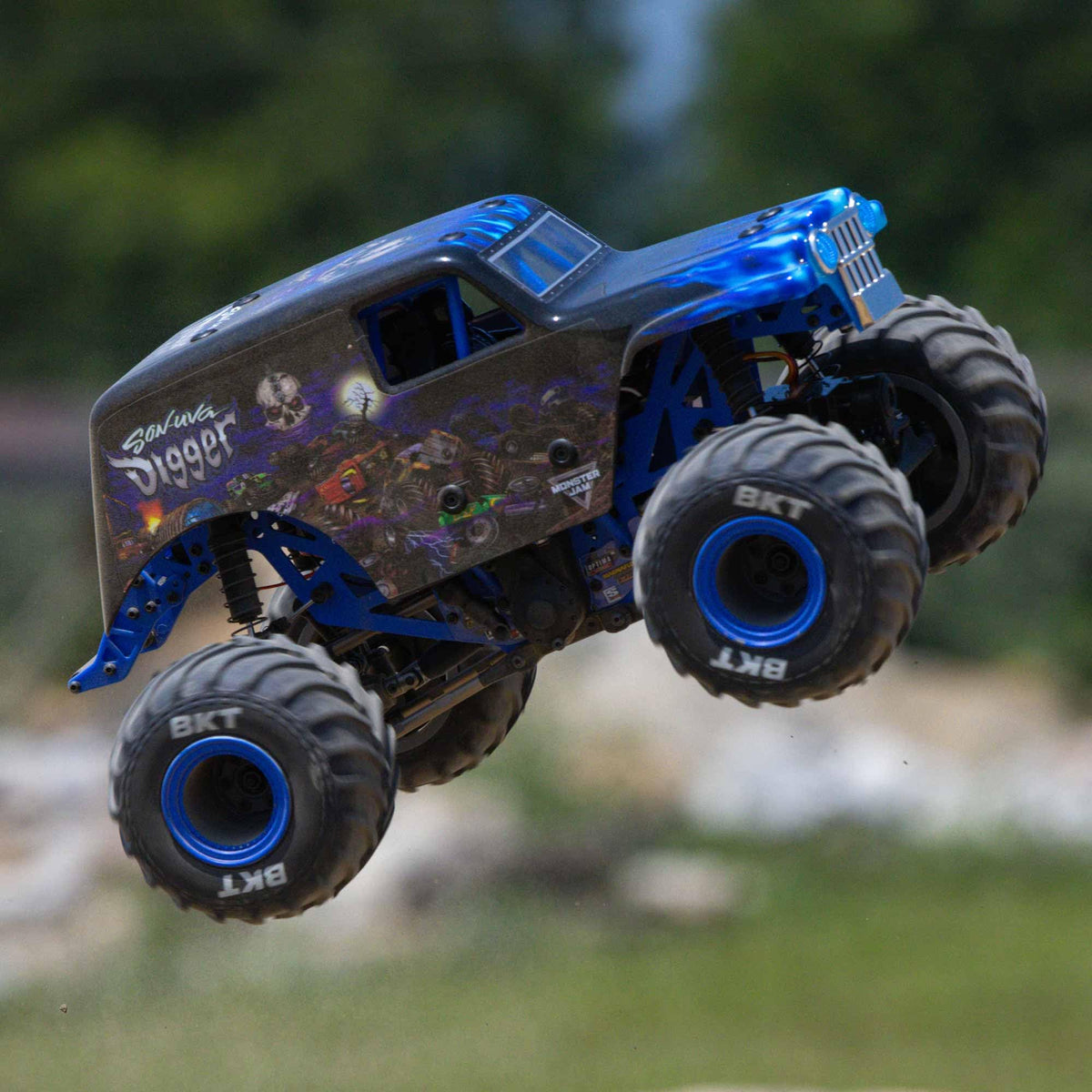 Losi 1/18 Mini LMT Son Uva Digger side profile left emphasizes stability on rough surfaces.